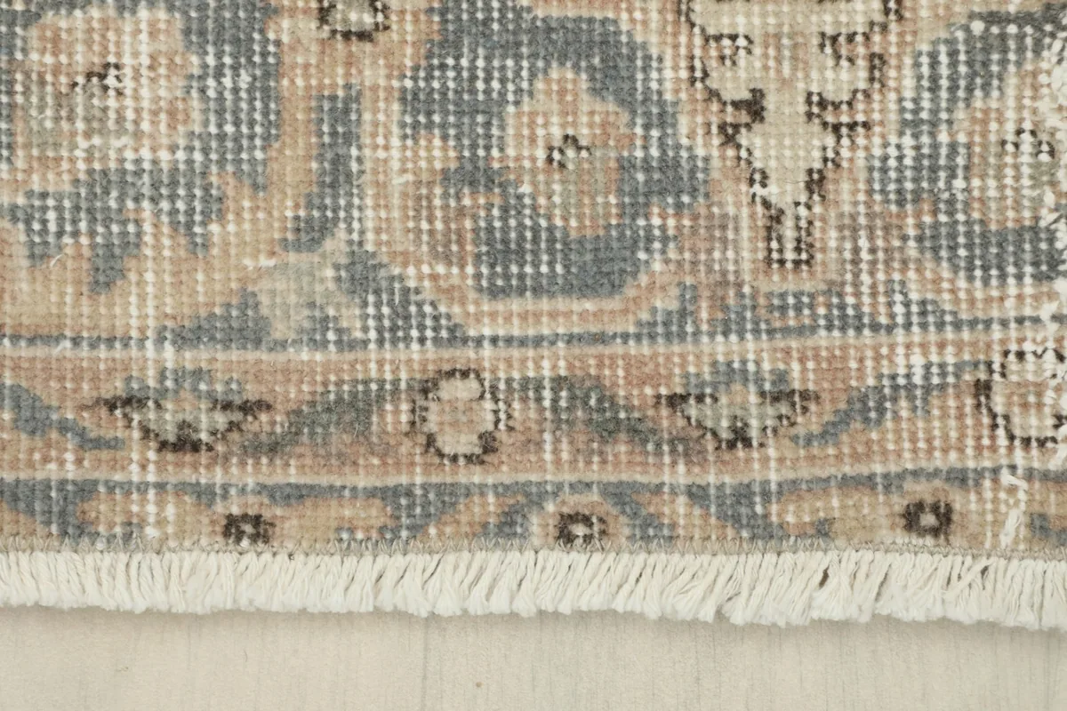 Close-up of the rug's fringe and a section of the border pattern