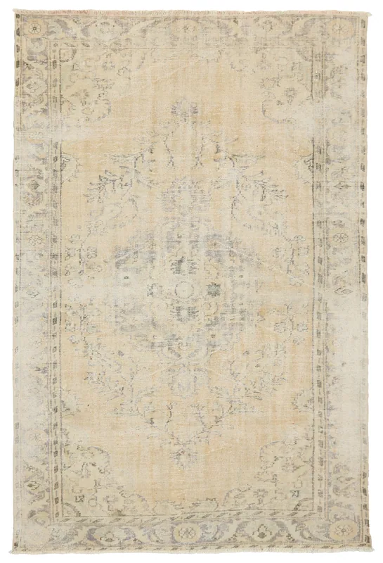 Full top view of the 5'1" x 9'1" beige and gray vintage Anatolian area rug on a white background.