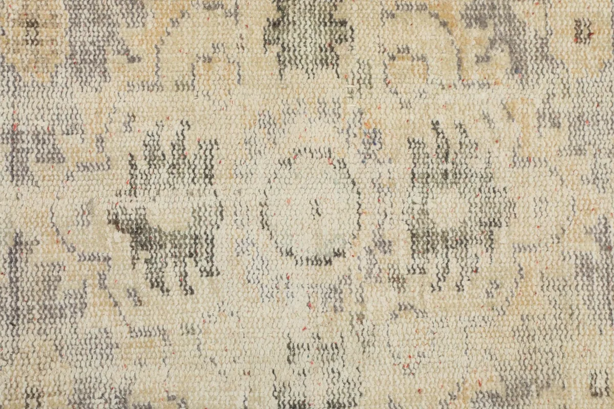 Close-up of the low pile and texture of the hand-knotted wool, showing the weave and wear.