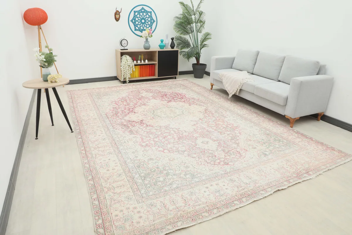 Rose Ivory Medallion Anatolian Rug in a living room setting, showcasing its oversized dimensions and soft color palette.