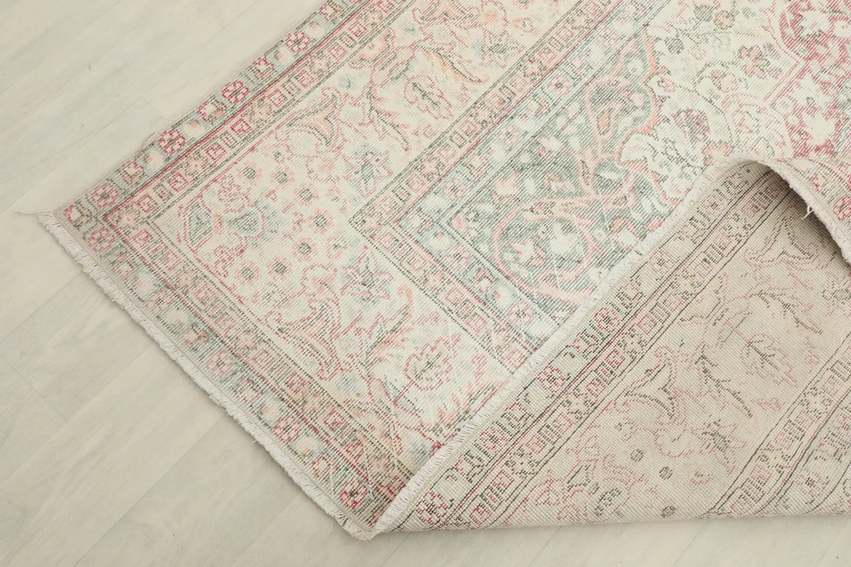 Corner of the Rose Ivory Medallion Anatolian Rug folded back, showing the back of the hand-knotted construction.