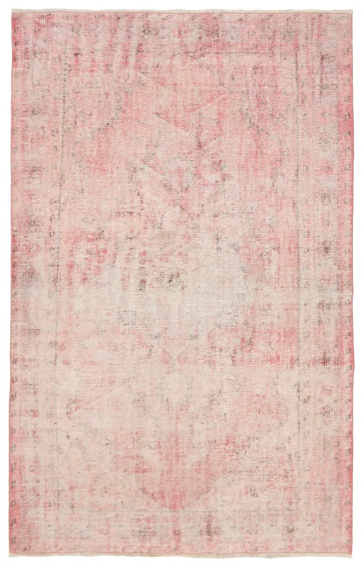 Full overhead view of the rose faded vintage Anatolian rug on a white background.