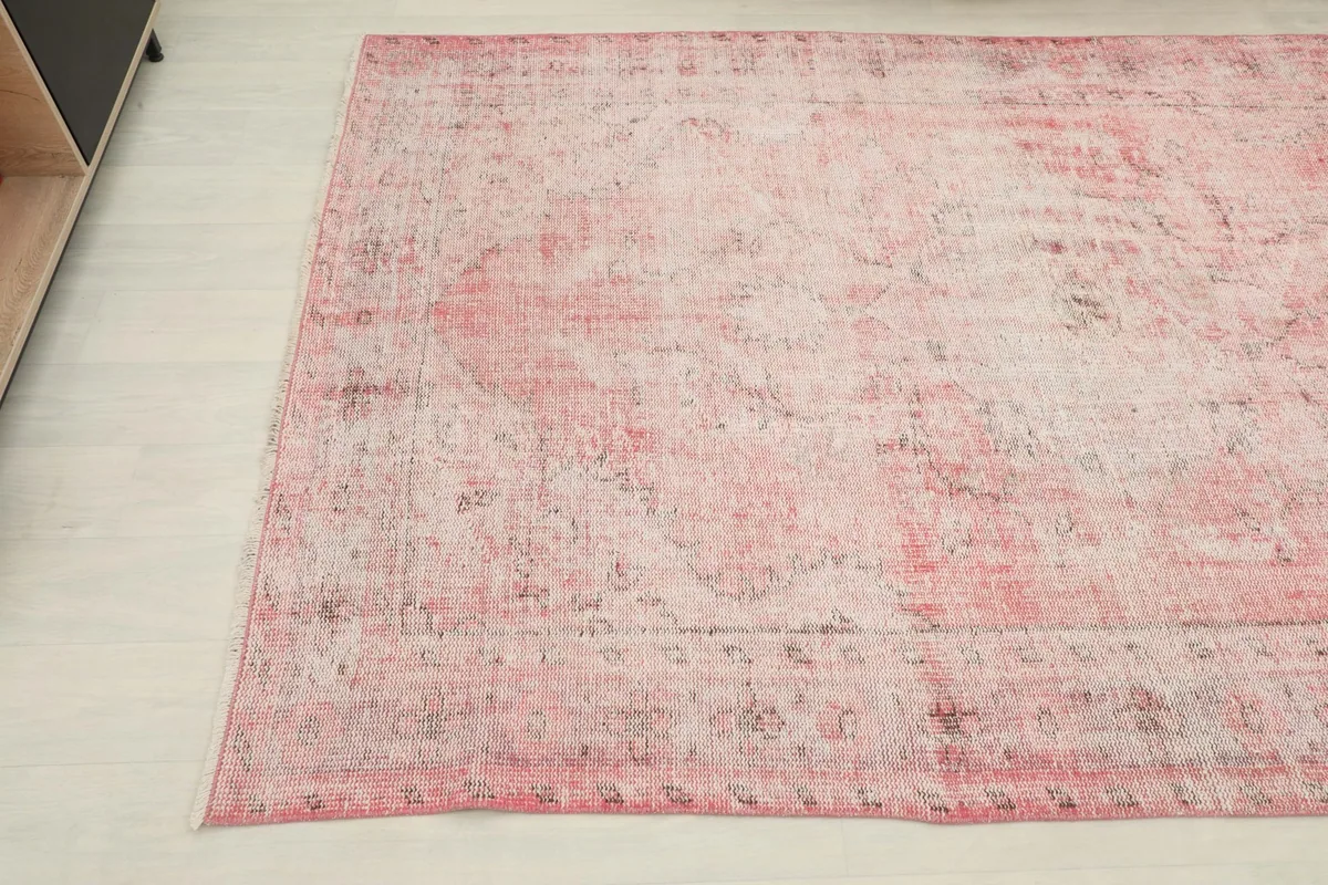 Another angle shot highlighting the distressed texture and color variation across the rug's surface.