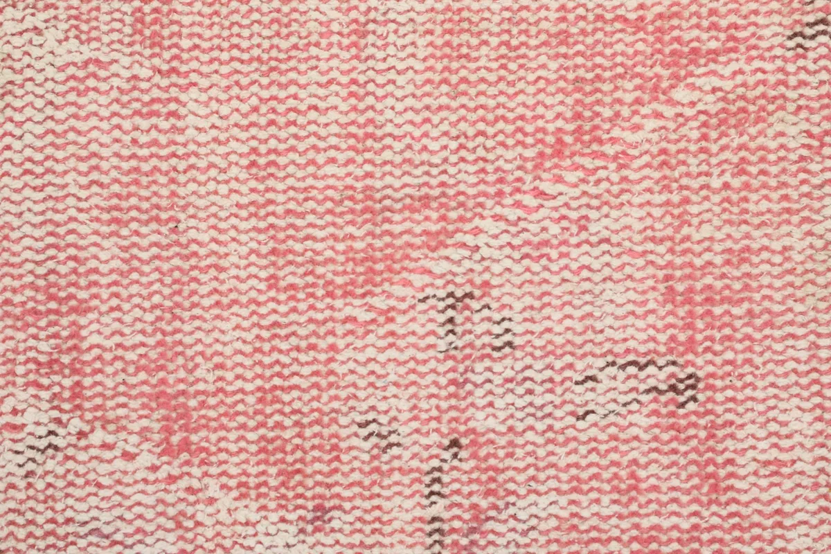 Extreme close-up of the hand-knotted wool pile, revealing the varied texture and color blending.
