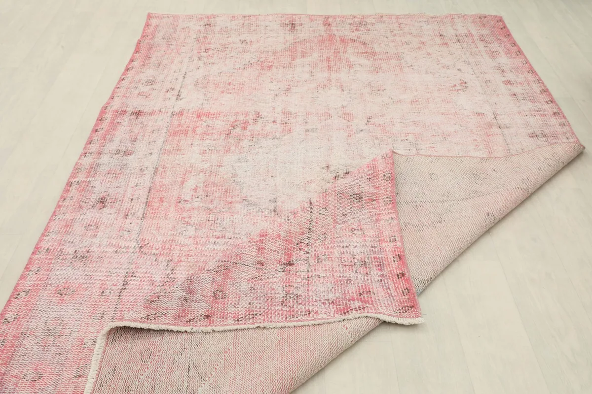 View of the rug with a larger section folded back, showing the consistent construction from front to back.