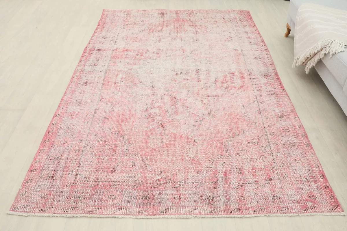 Full overhead view of the rose faded vintage rug, positioned on a light floor.