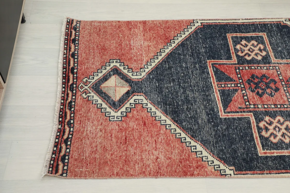 Angled view showing the other end of the vintage runner rug and its distinctive pattern