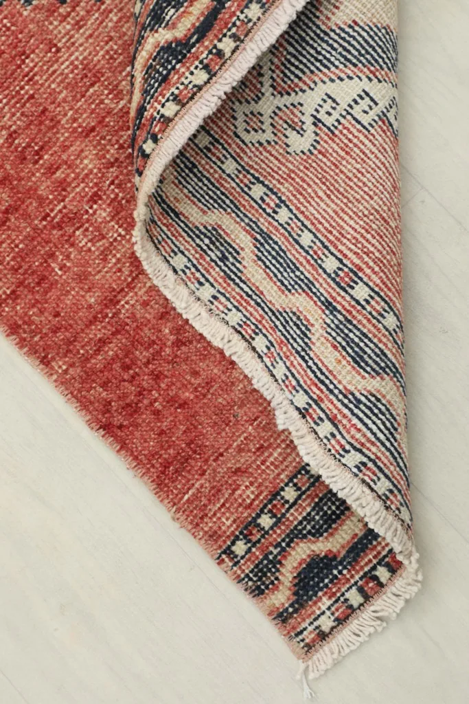 View of the back of the hand-knotted rug, revealing the cotton foundation and construction