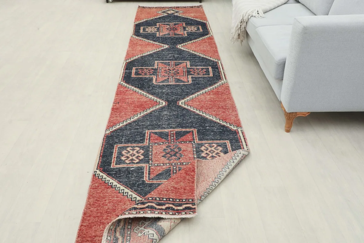 Runner rug partially folded, showcasing its flexibility and the consistent pattern from top to underside