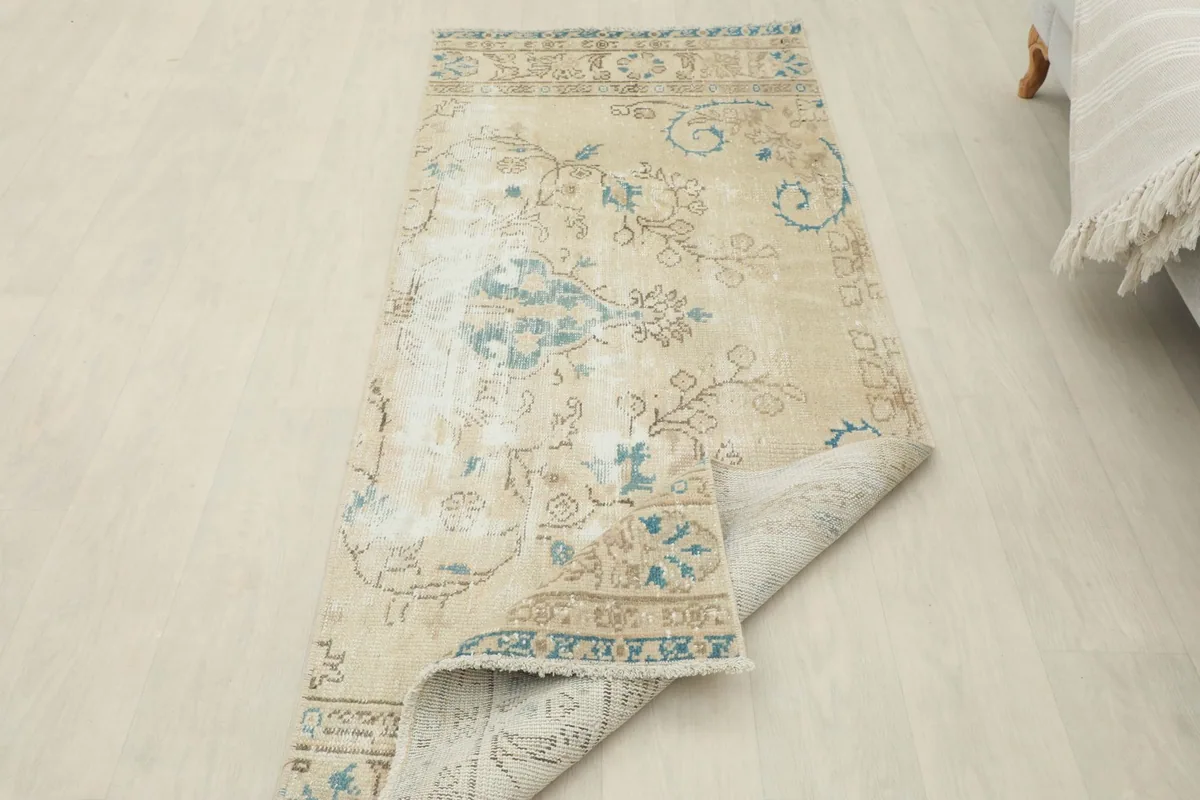 Runner partially folded, showing the flexibility and thickness of the vintage wool pile
