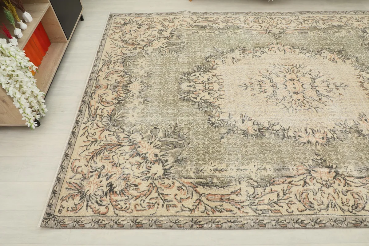 Overhead angle view capturing the intricate floral border and central medallion of the rug.