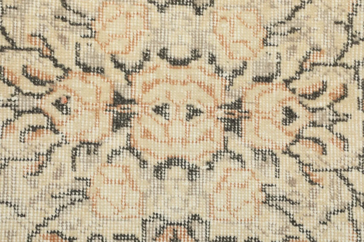 Extreme close-up of the wool pile and knotting, showing the texture and color variations.