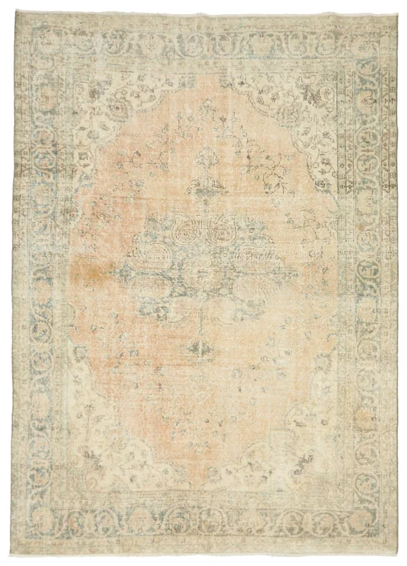 Full top view of the 6'9" x 9'8" vintage Anatolian area rug with a faded orange field and blue medallion