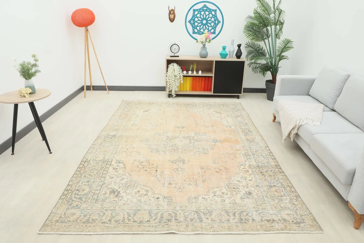 Full view of the 7x10 vintage Anatolian rug in a living room, providing a sense of scale
