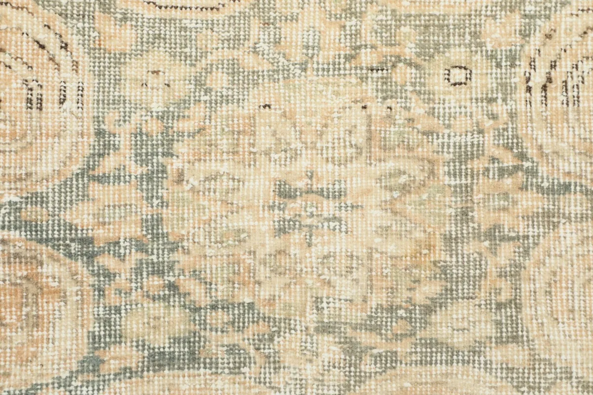 Close-up of the low wool pile, revealing the hand-knotted texture and color variations