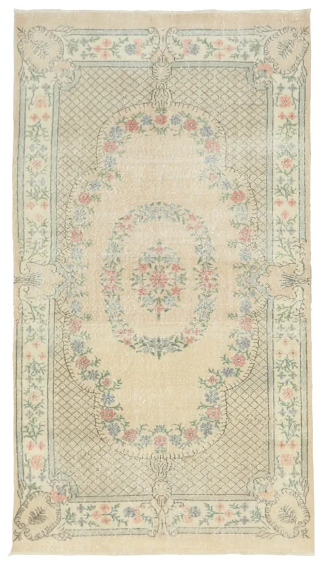 Full top view of the ivory, rose, blue, and green vintage Anatolian area rug.