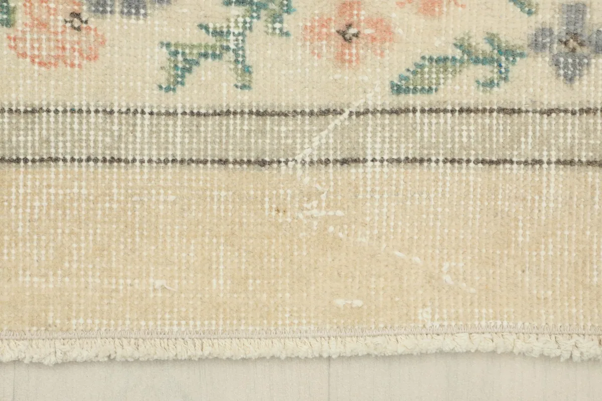 Detail showing the low pile height and the texture of the vintage wool on cotton foundation.