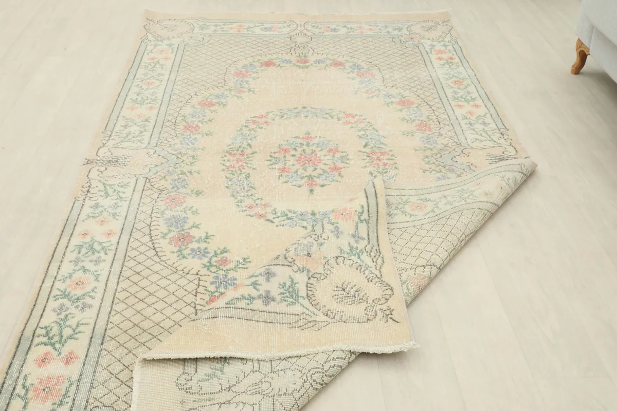 Rug partially folded, illustrating its flexibility and the overall design.