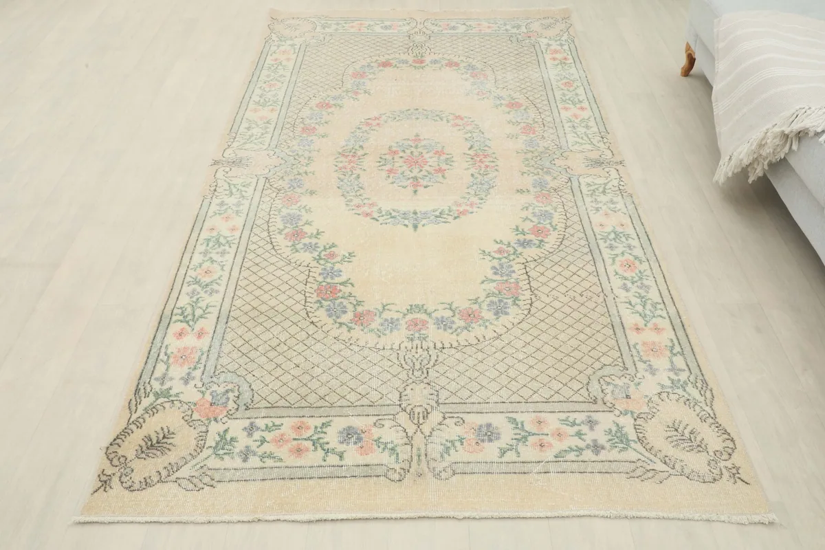 Full overhead view of the ivory vintage rug, showcasing the complete design in a room setting.