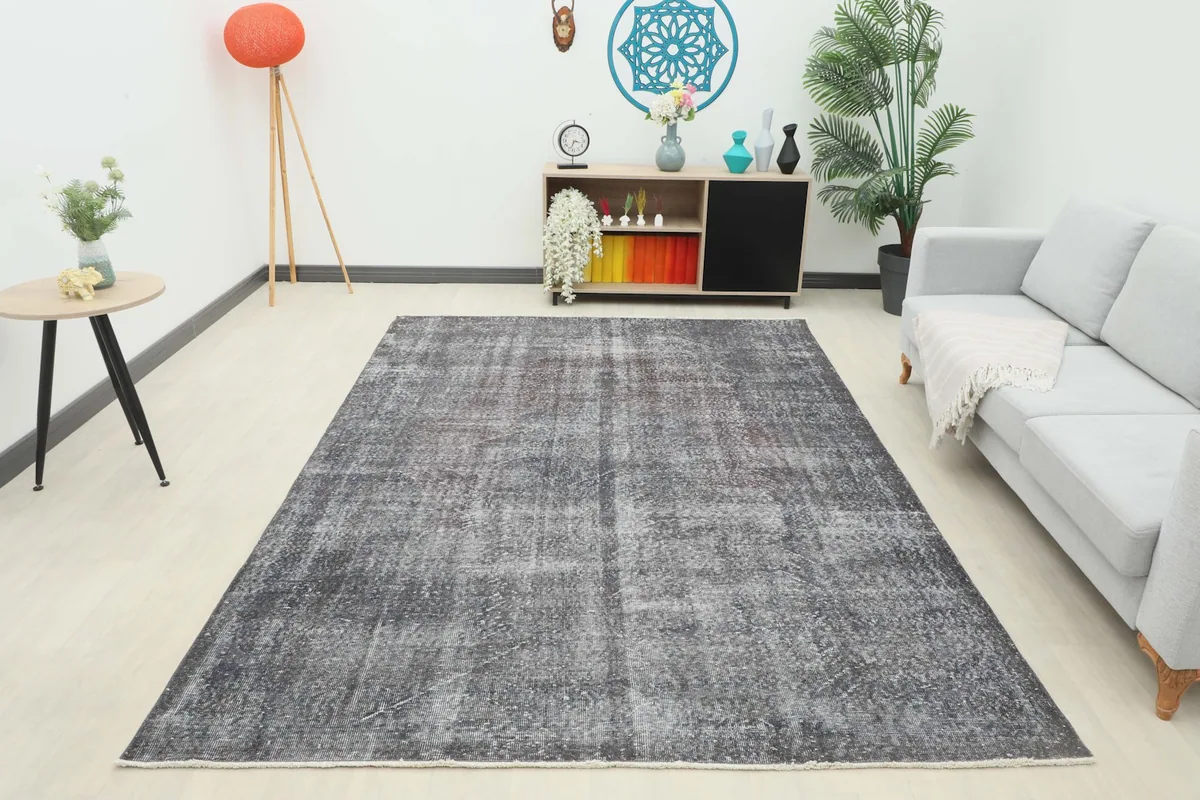 Full view of the charcoal vintage rug in a living room with modern decor
