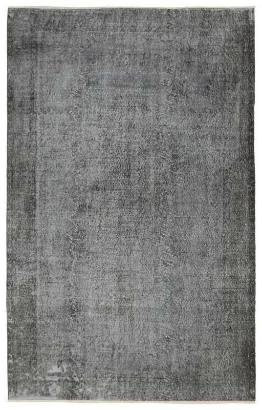 Full overhead view of the 5'8" x 9'3" charcoal vintage Anatolian area rug on a white background.