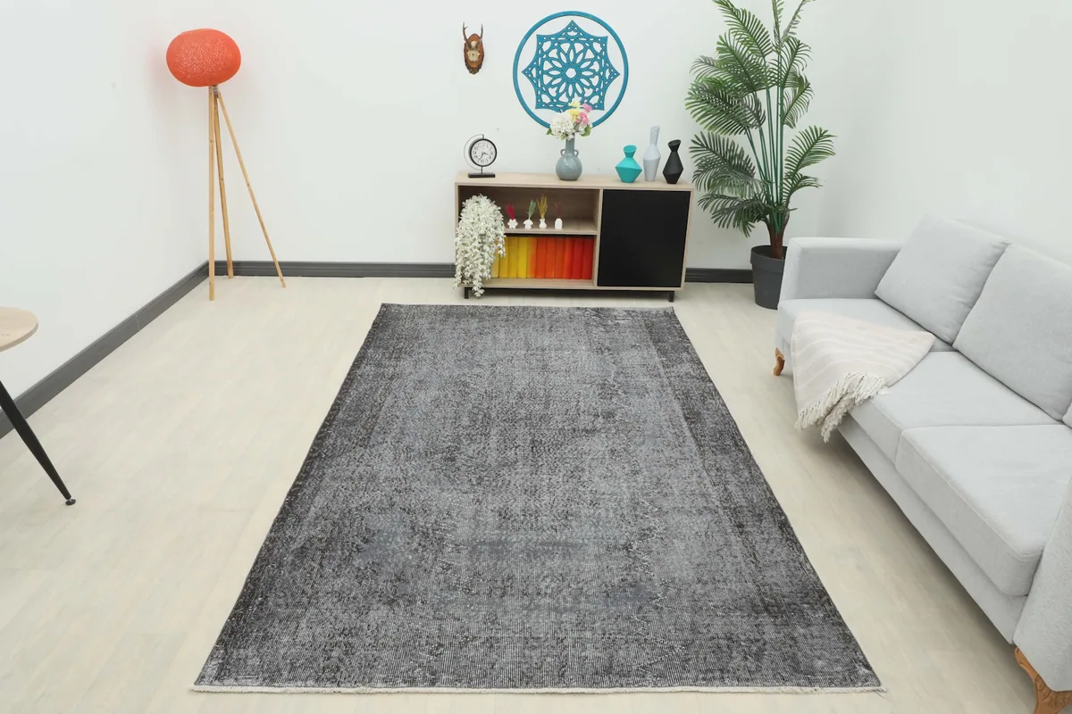 Full room view of the charcoal vintage rug, showcasing its size and impact in a contemporary space.