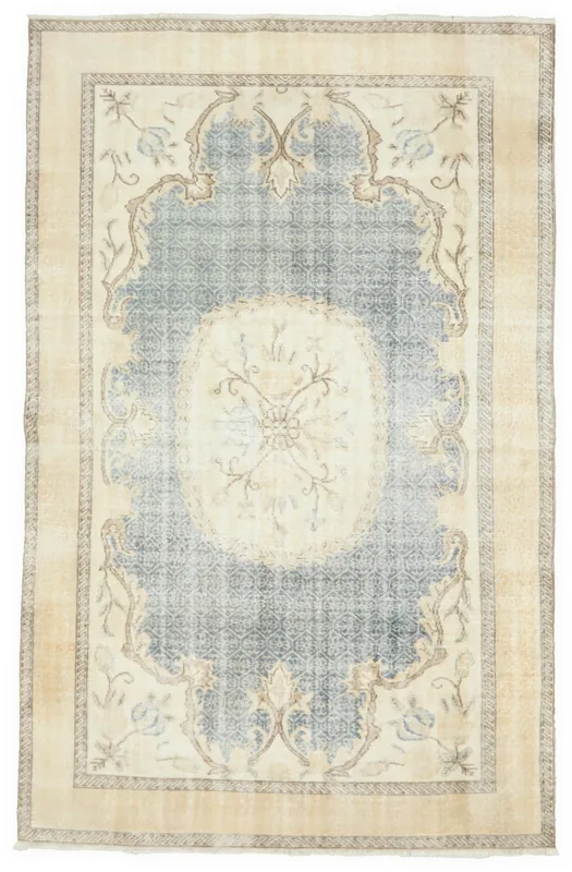 Full top view of the vintage blue and cream Anatolian rug on a white background