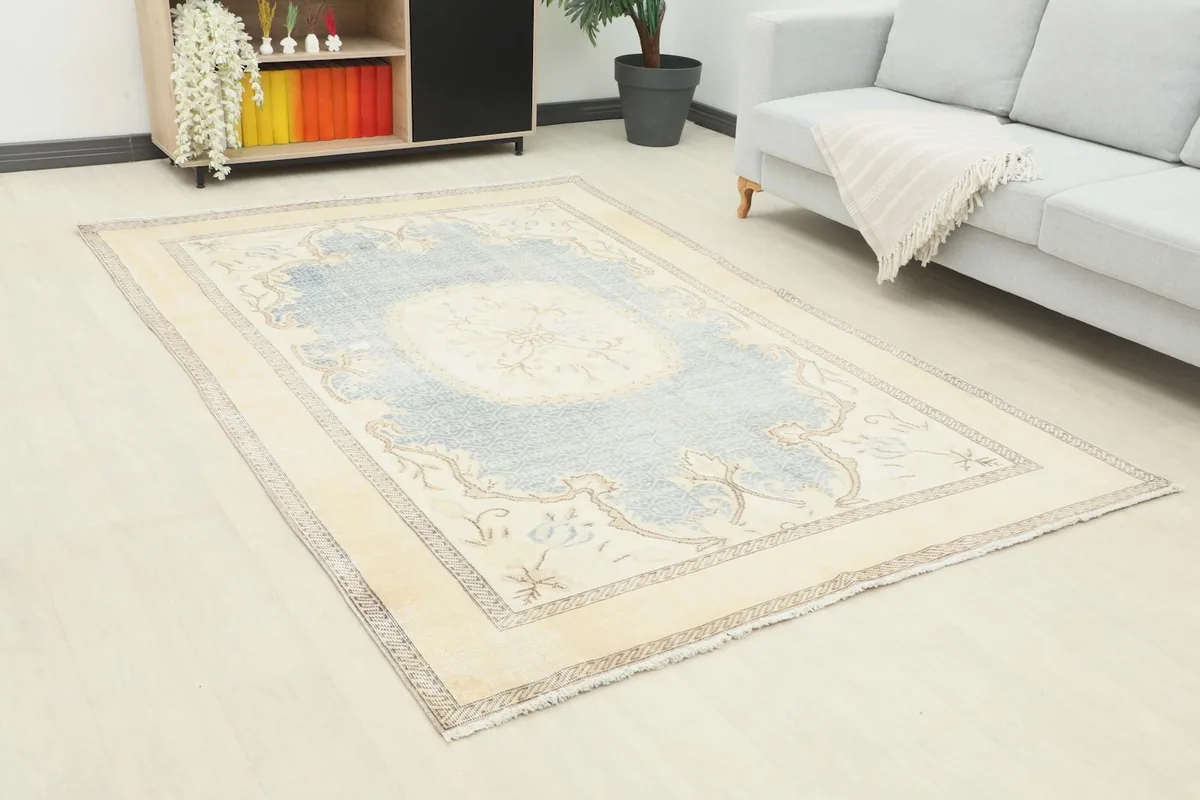 Angle view of the blue and cream rug in a room, showing its placement relative to furniture