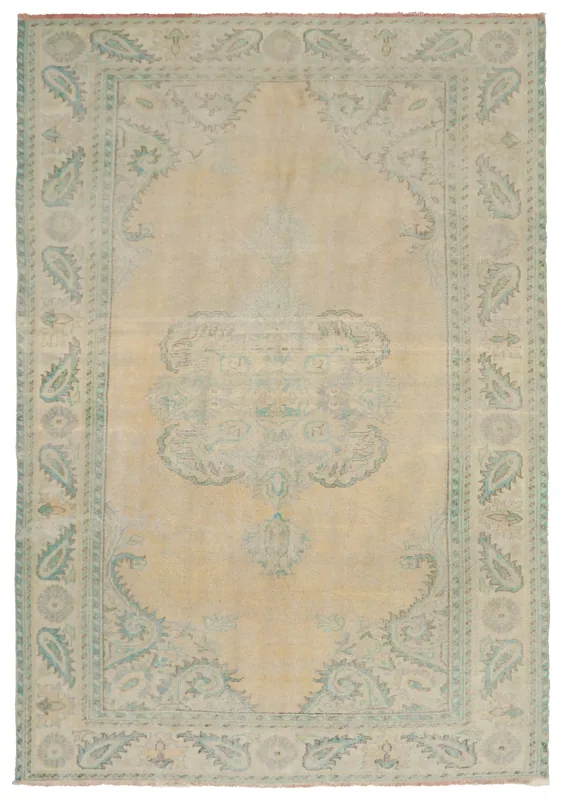 Full top view of the vintage beige and green Anatolian area rug on a white background