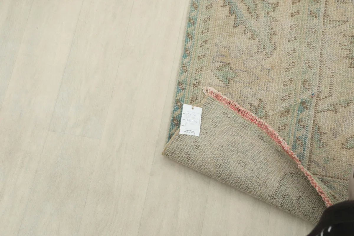 View of the rug's back, showing the tight hand-knotted wool pile on cotton foundation