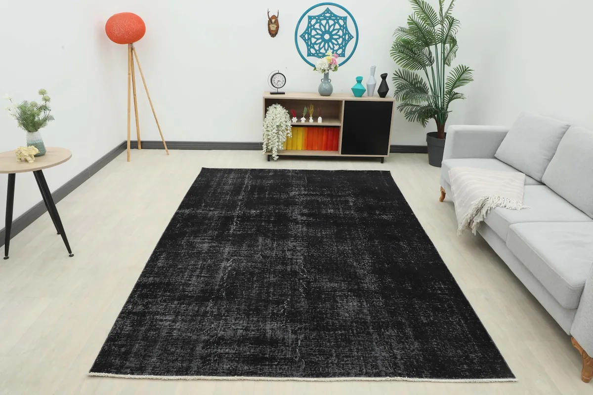 Full room view of the black and gray distressed rug as a central piece in a living space