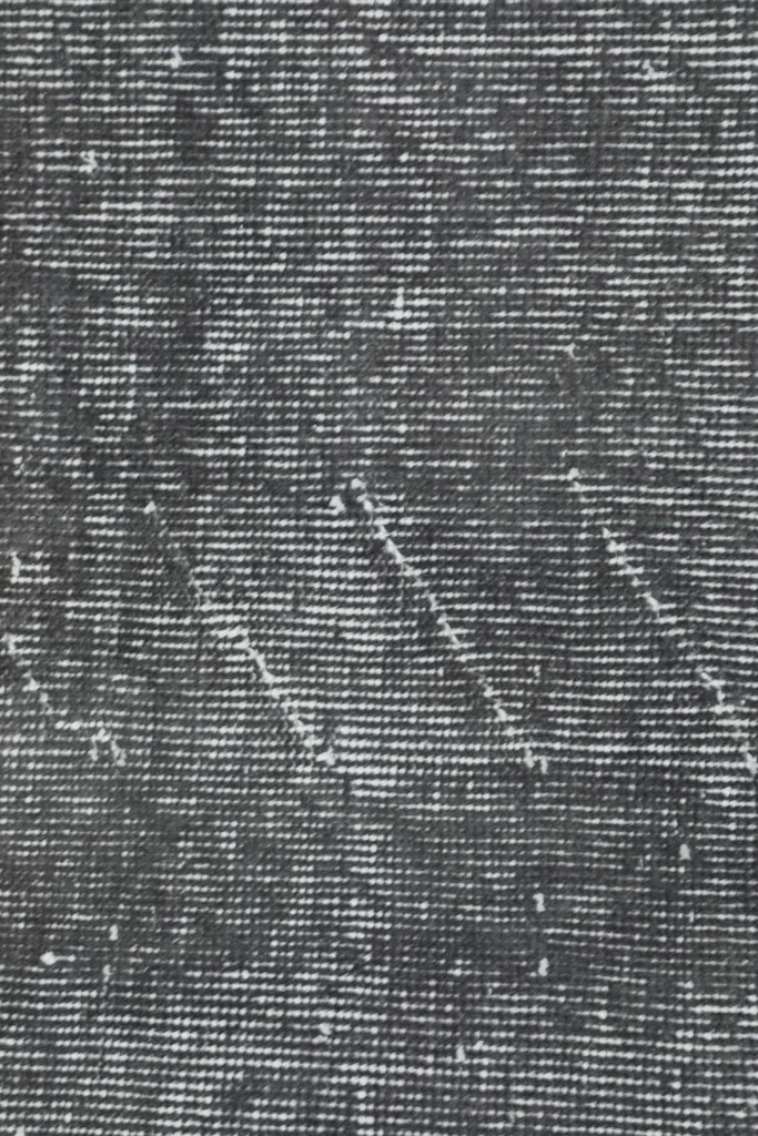 Close-up of the hand-knotted wool pile and faded texture