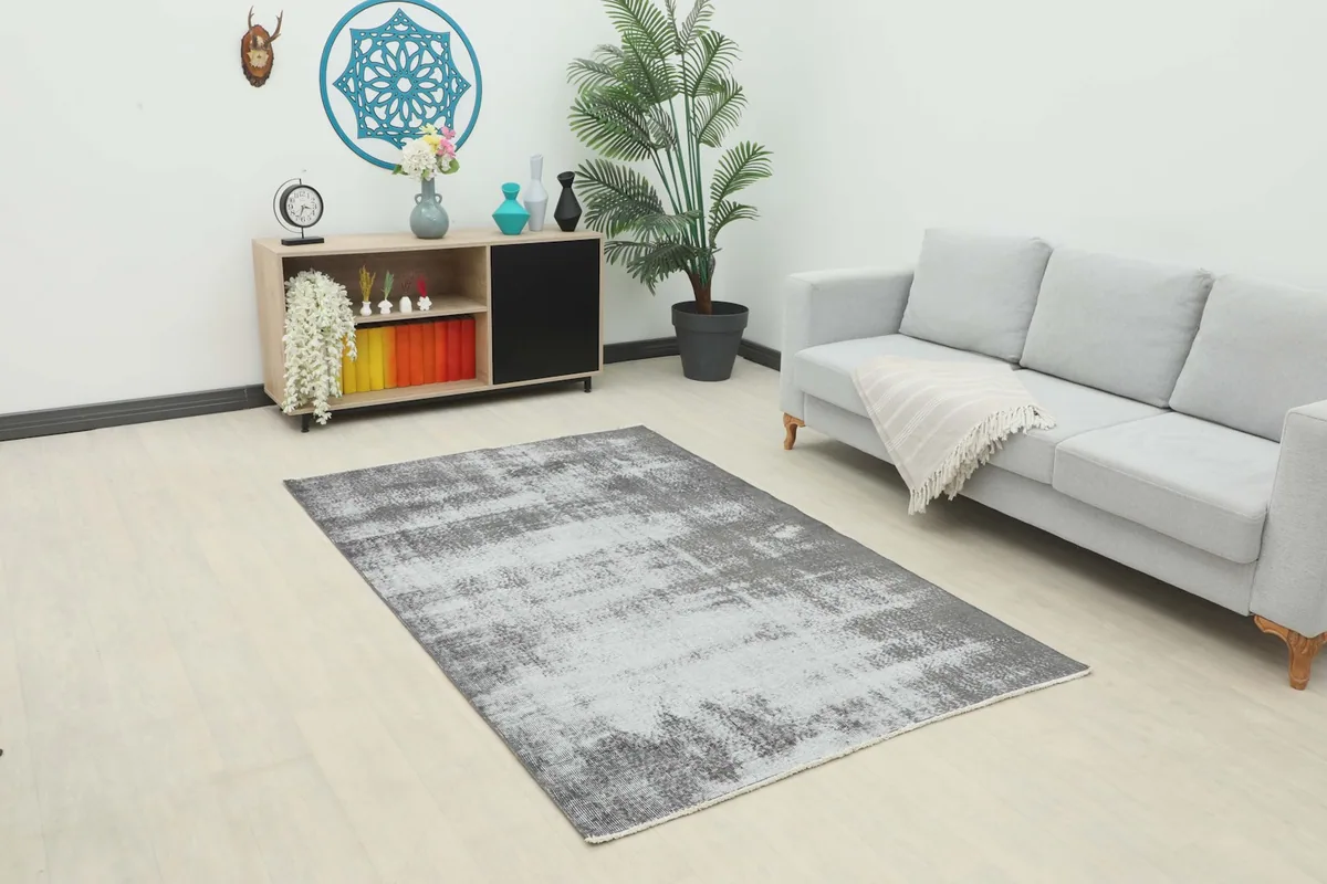 Vintage charcoal and gray rug showcased in a modern living room setting with a light gray sofa.
