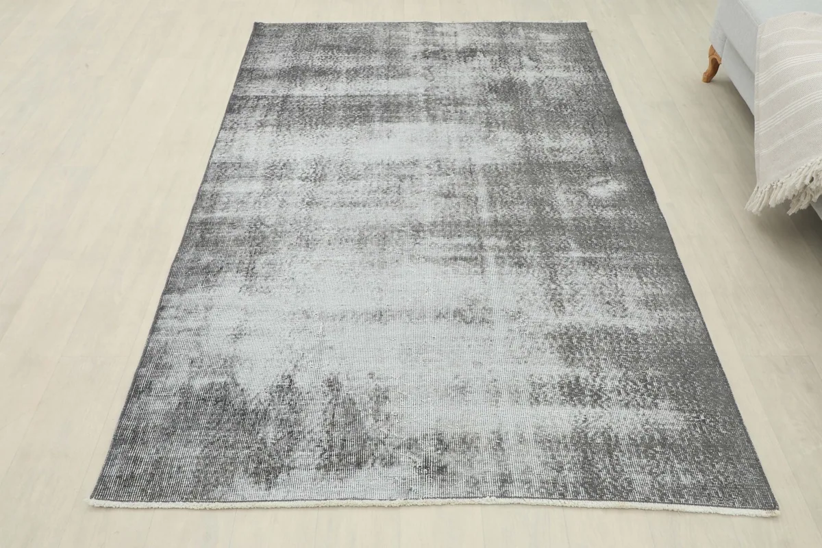 Full overhead shot of the charcoal and gray rug, providing a complete view of its distressed aesthetic.