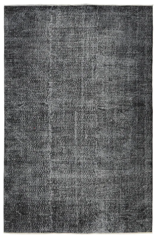 Full overhead view of the charcoal and gray distressed vintage Anatolian rug on a white background.