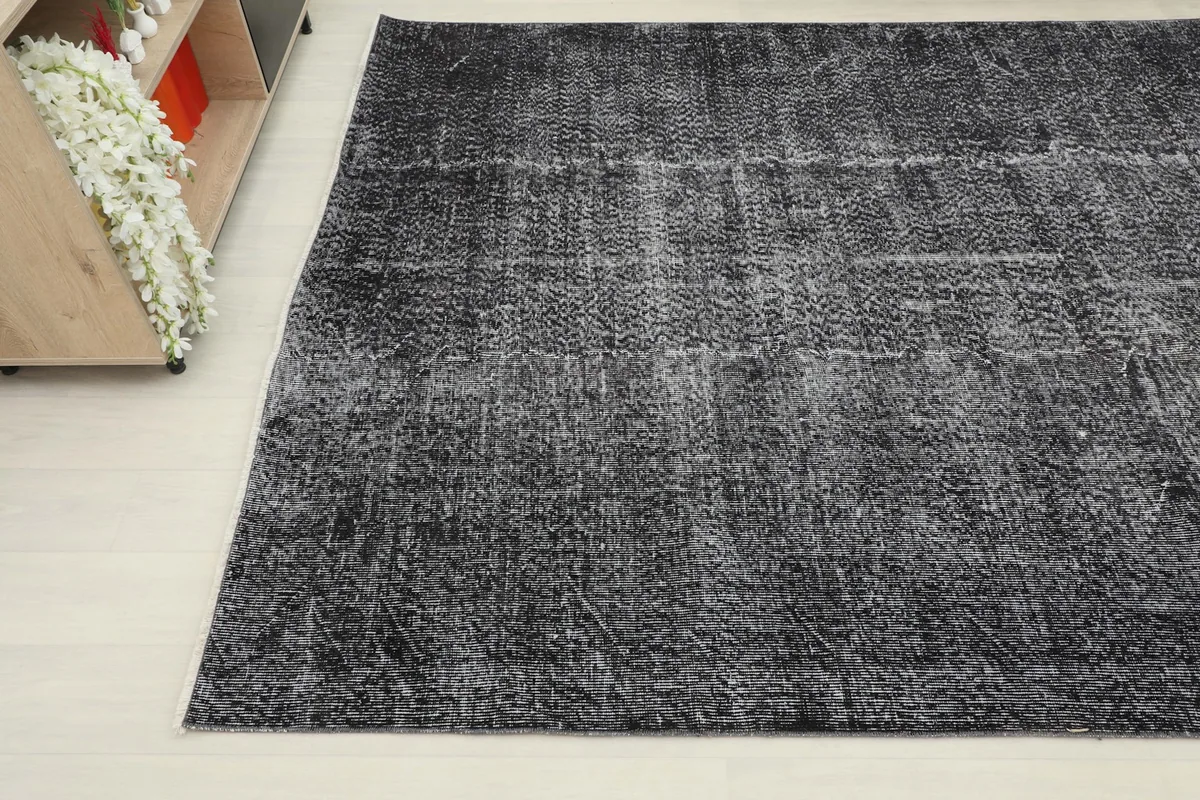 Another angle shot highlighting the faded areas and overall patina of the vintage rug.