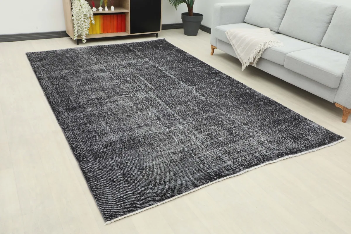 Angle view of the large charcoal vintage rug complementing a contemporary living space.