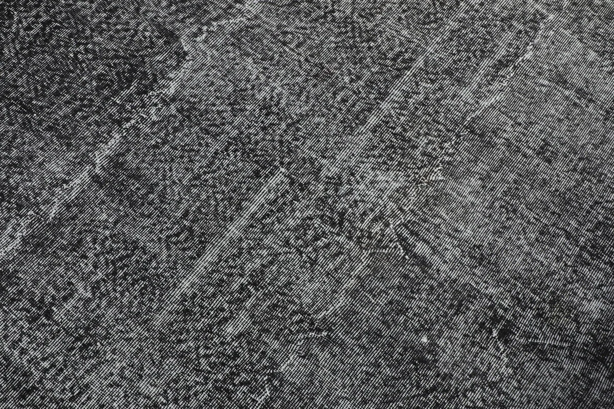 Detailed close-up of the distressed wool pile, revealing subtle patterns and wear.