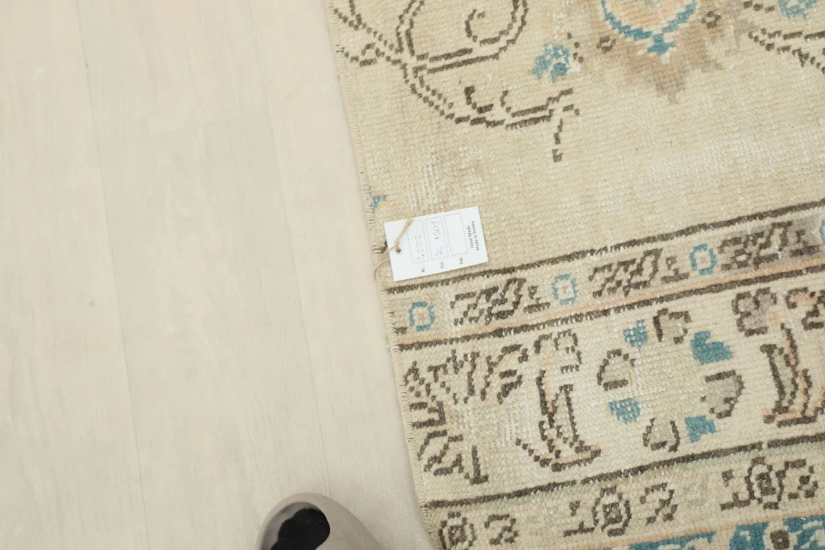 Corner of the rug with a label, indicating its origin and material details.