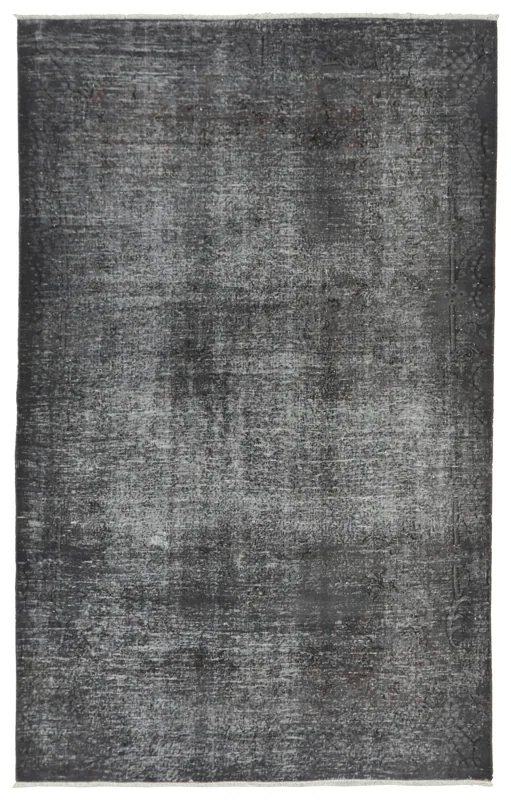 Full overhead view of the charcoal gray distressed area rug on a white background