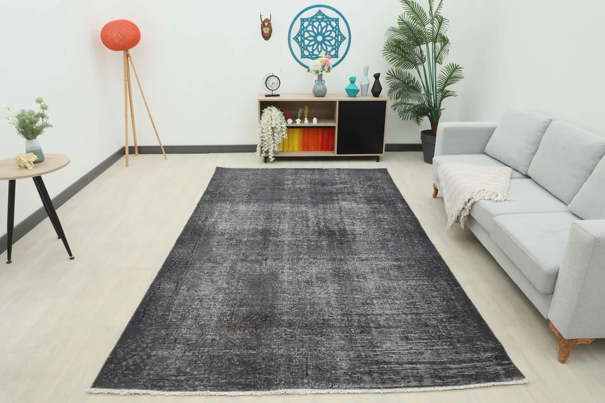 Full room view of the charcoal gray rug in a bright living space with diverse decor