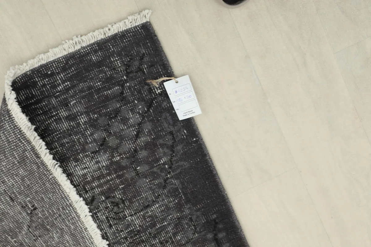 Detail of the rug's tag attached to the corner, showing product information