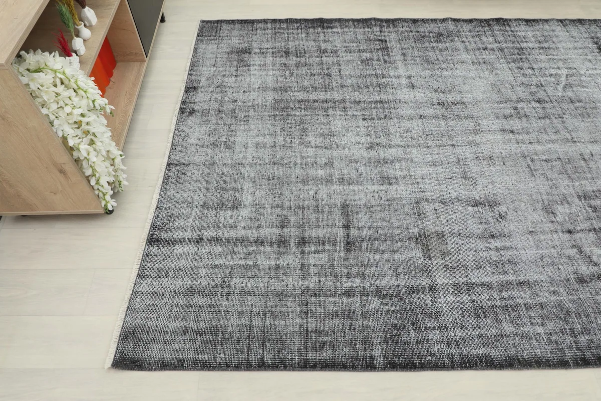 View of the vintage rug from another angle, highlighting its placement in a room