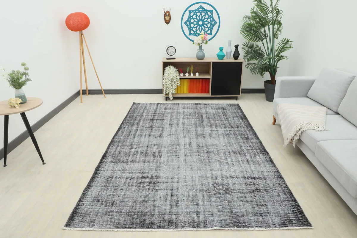 Full room view of the charcoal and gray vintage rug, showcasing its overall impact