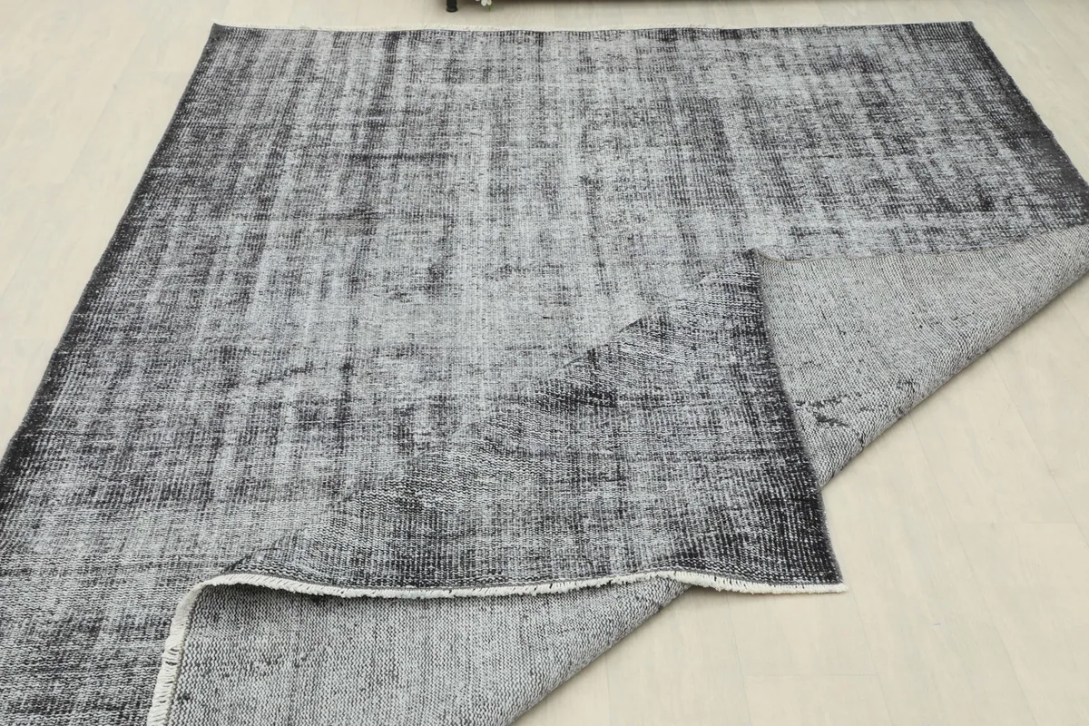 Large fold of the rug revealing the sturdy cotton foundation and hand-knotted structure