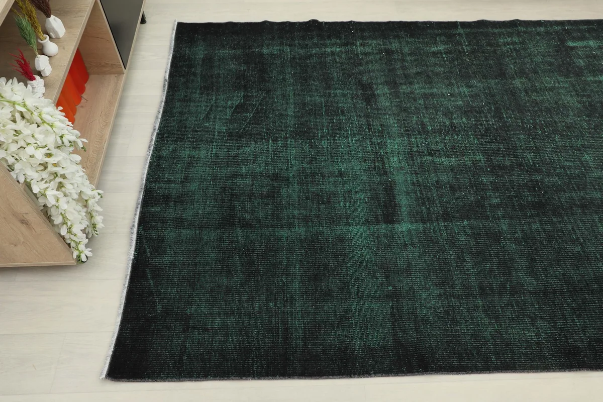 Overhead angle of the rug showing its placement next to a cabinet, emphasizing its rectangular shape.