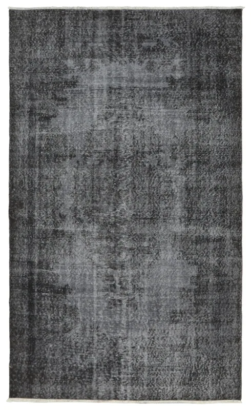 Full overhead view of the charcoal gray distressed area rug on a white background