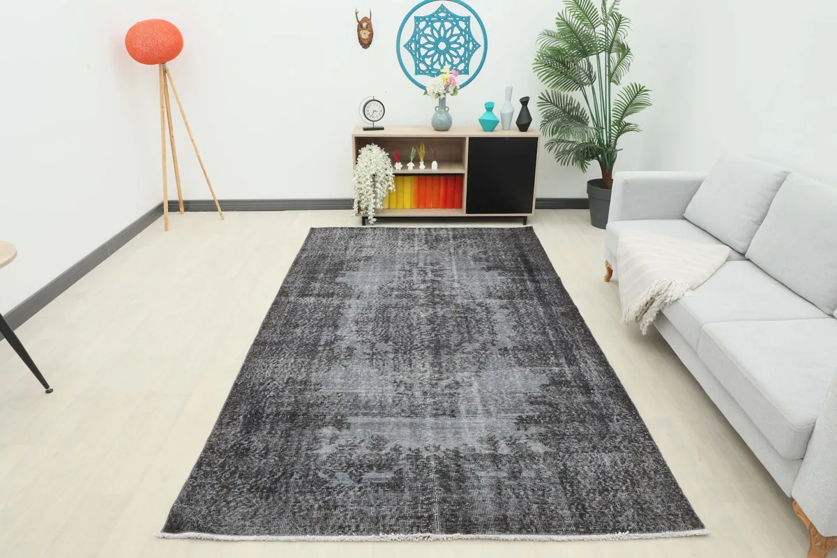 Full room view of the charcoal distressed rug, showcasing its size and impact in a space