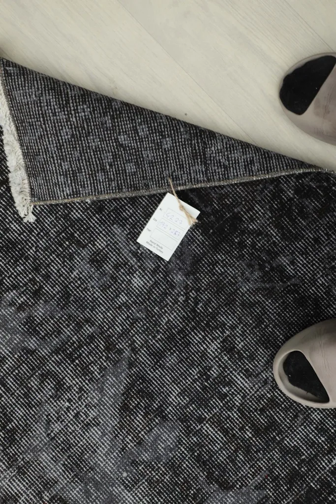 Overhead view of a folded corner with a product tag, indicating its authenticity