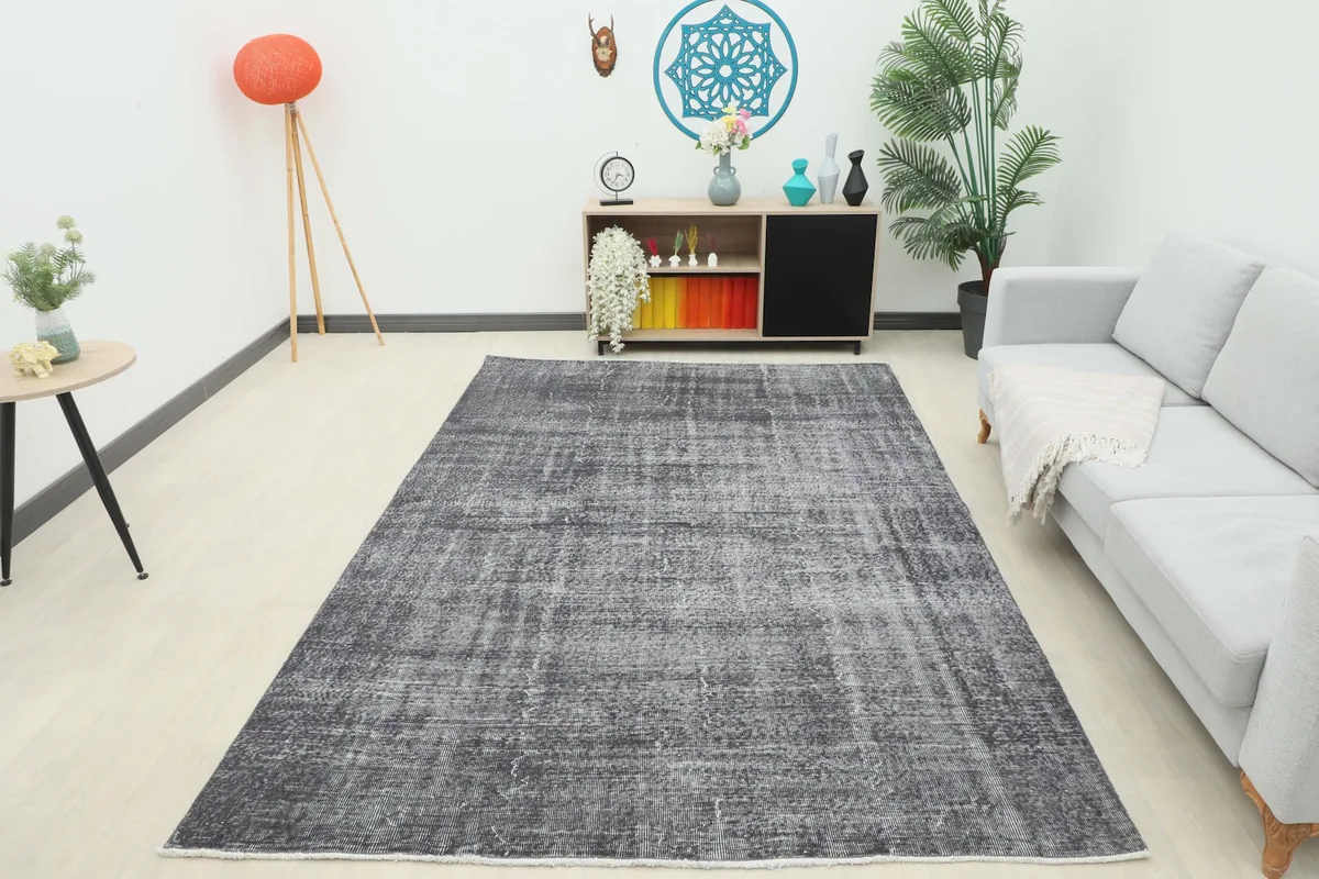 Full room view of the charcoal gray vintage rug, showcasing its size and impact in a contemporary living space.